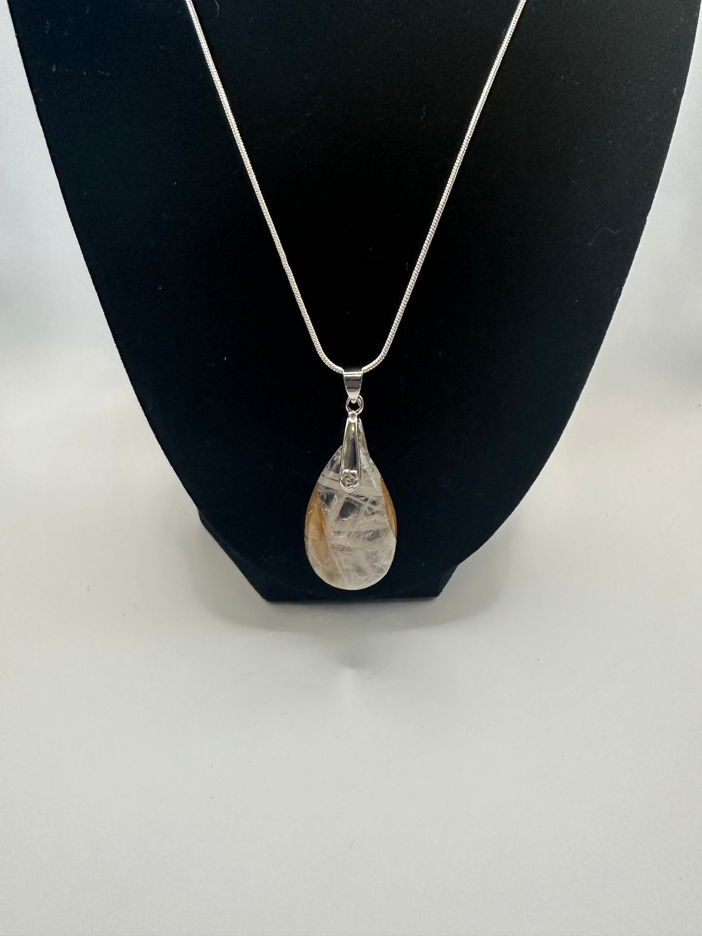 Clear quartz pendant with golden healer